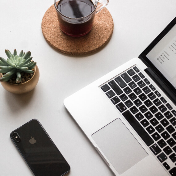 tablet and mobile phone with coffee at a desk