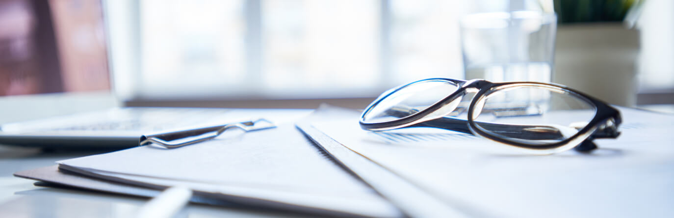 Glasses sitting on documents