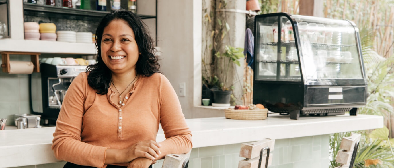 Female business owner smiling in store