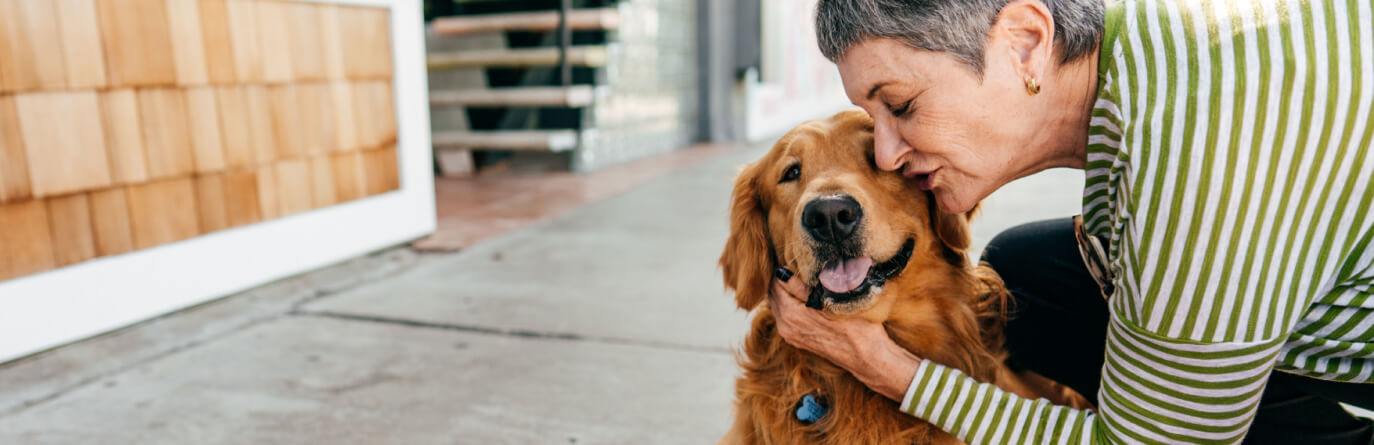 Woman cuddling dog