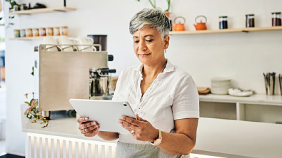 Female business owner using tablet device in store