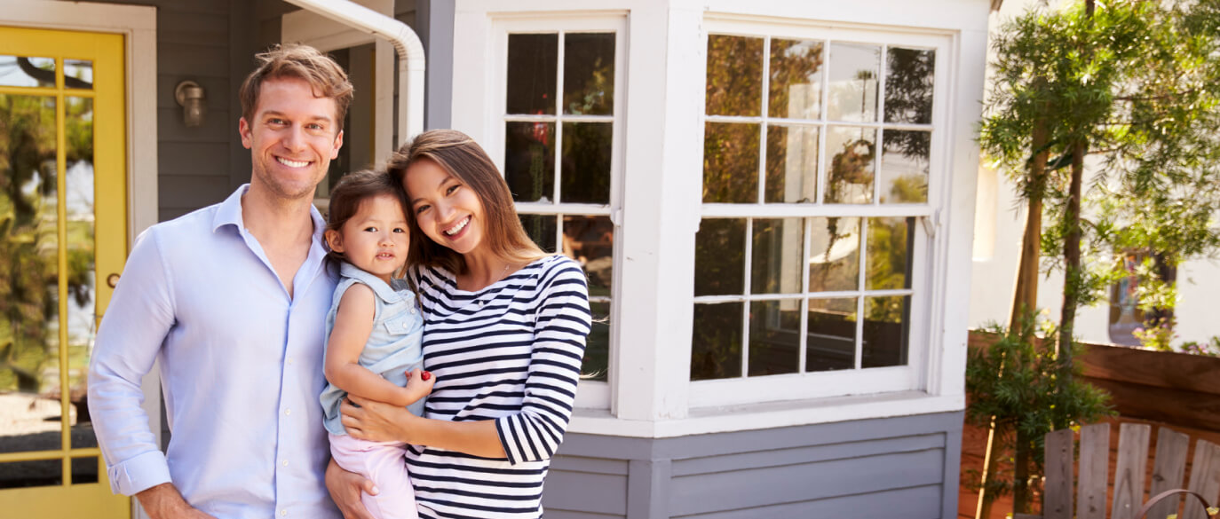 Couple with young daughter outside of home