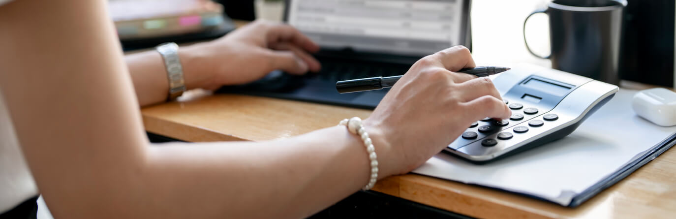 Person using calculator at a desk